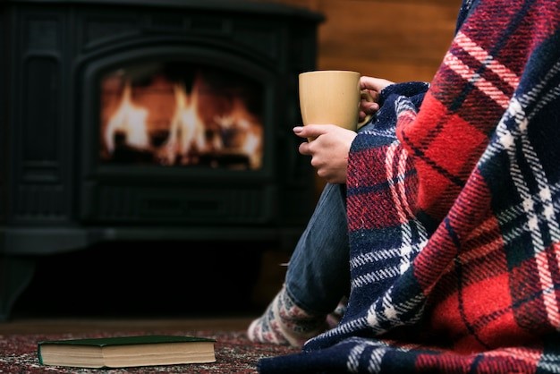 Staying warm by fireplace